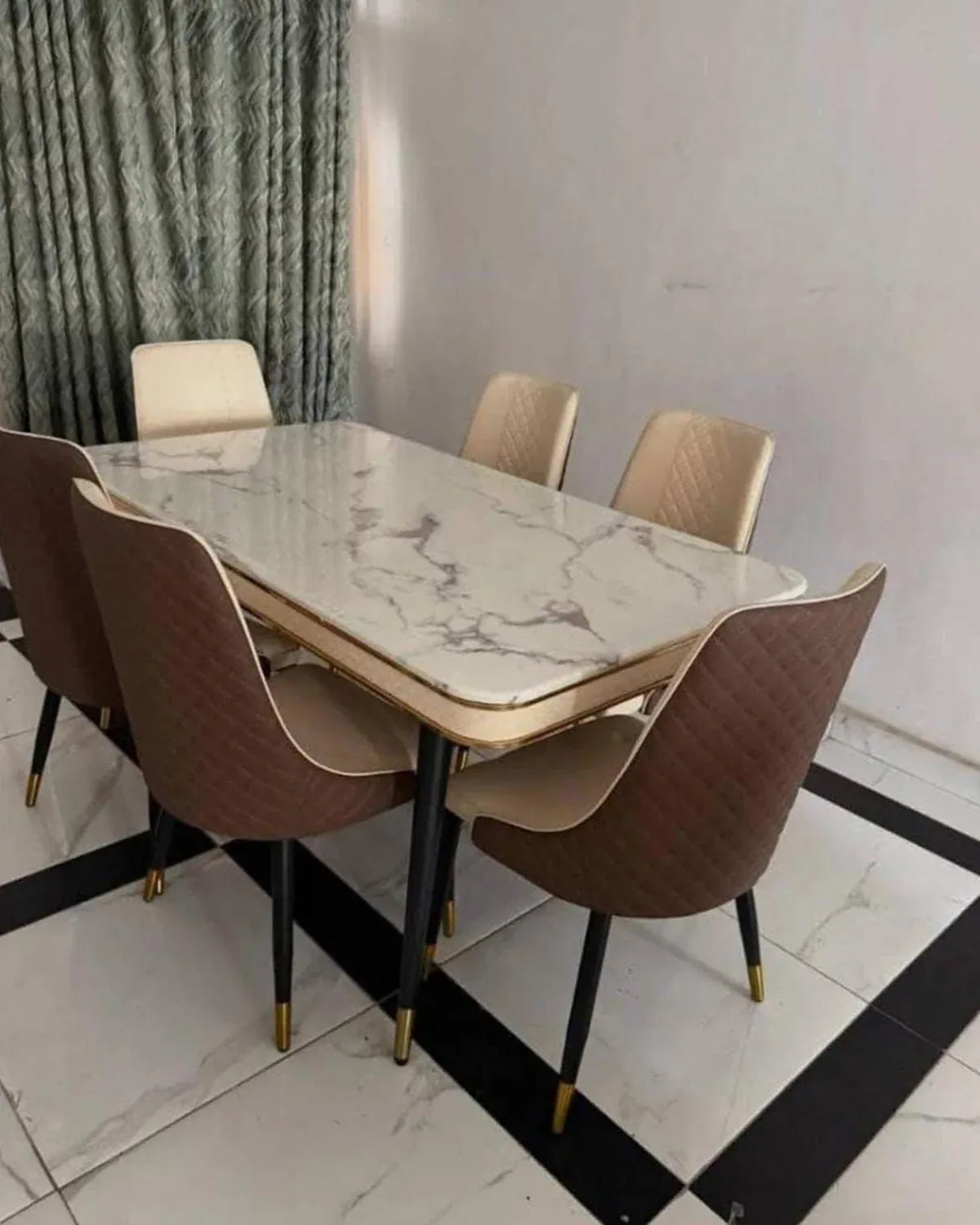 Marble-look dining table with neutral upholstered chairs