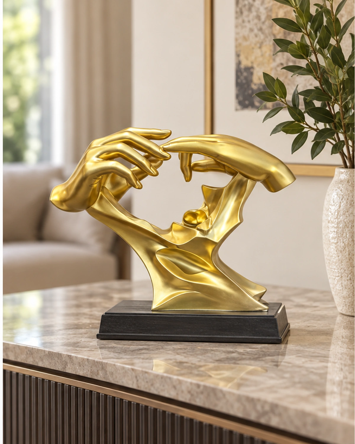 Golden Reaching Hands sculpture on a coordinated console