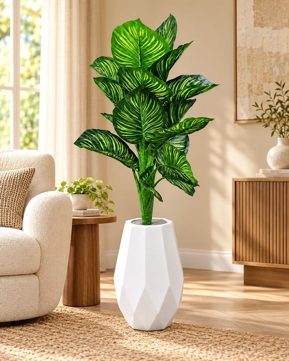 Green artificial plant in a white faceted vase